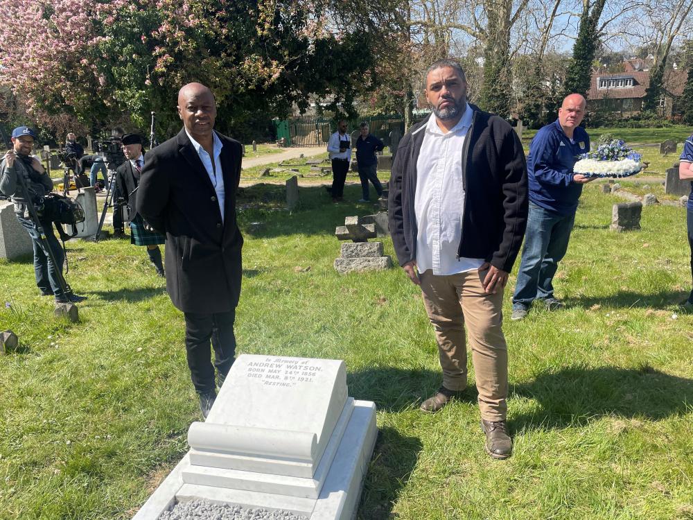 Malik Al Nasir and footballer Mark Walters standing by a grave