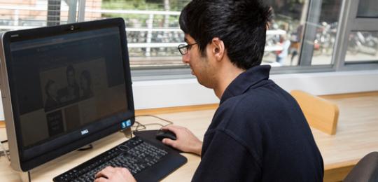 Image of someone working at a laptop