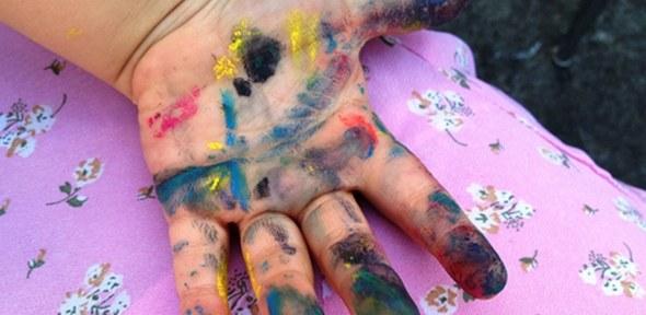 child's hand with paint on